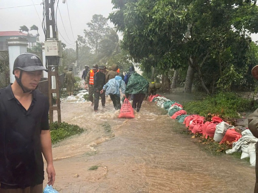 Các hộ dân tại tổ dân Thành Thắng cùng lực lượng chức năng khẩn trương dùng bao cát ngăn nước sông Mã tràn vào khu dân cư. 