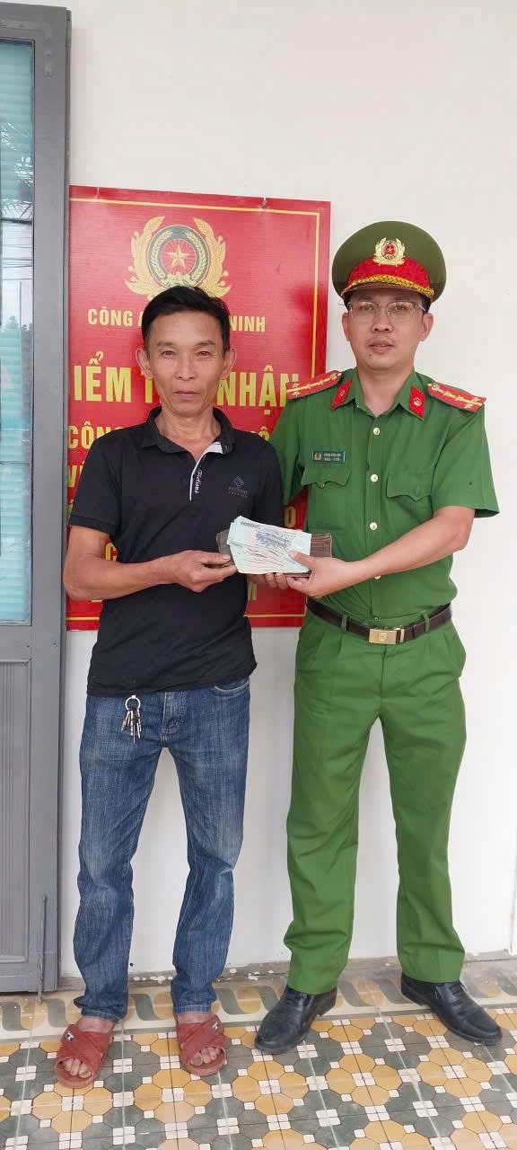 Anh Nguyễn Quang Tuyên (bên trái) nhận lại tài sản do Công an xã Phú Ninh trao trả sau khi bị đánh rơi. Ảnh: Công an xã Phú Ninh